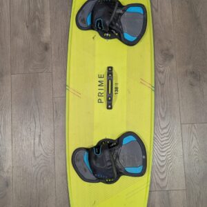 Bright yellow wakeboard with blue-and-gray bindings on a wooden floor.