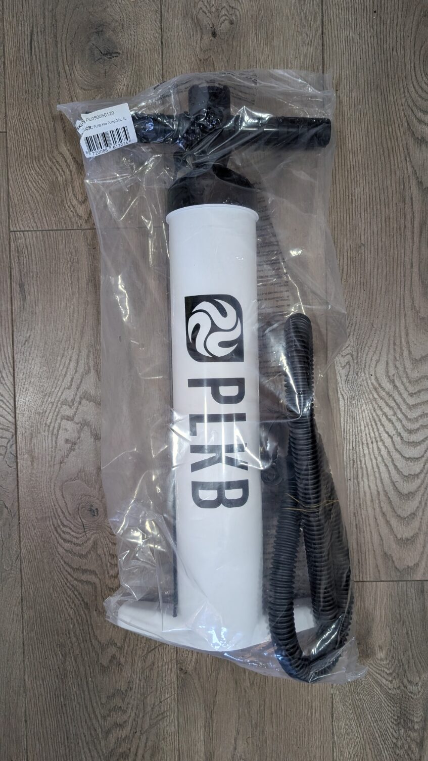 PLKB-branded white cylindrical device sealed in a clear bag with a black top and a flexible hose attached.